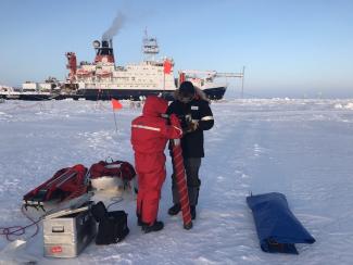 setting up the corer to collect ice core samples on the floe near Polarstern.