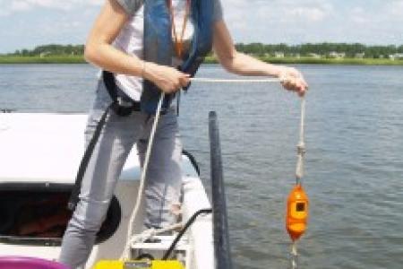 UGA Skidaway Institute researcher LeeAnn DeLeo lowers the sensor to measure conductivity, temperature and depth from the surface to the bottom